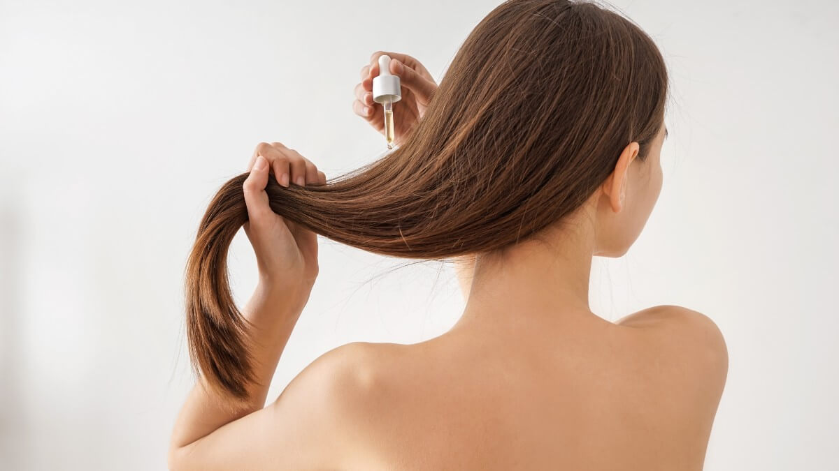 applying hair oil to hair