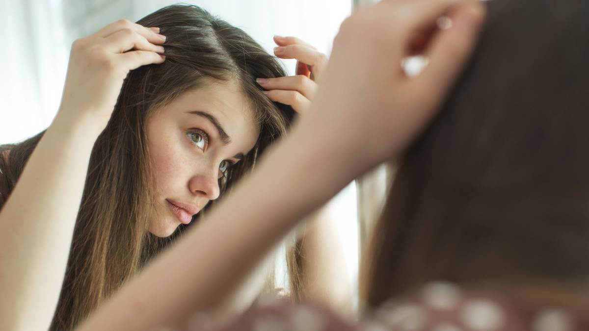 young woman checking hair 1